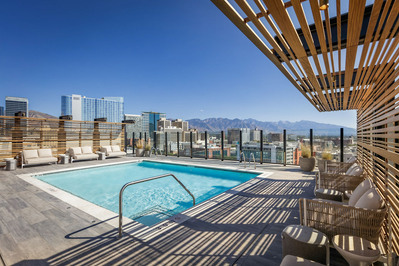Rooftop pool at Le Meridien Salt Lake City, offering stunning mountain views, captured in a vibrant hotel photography setting.