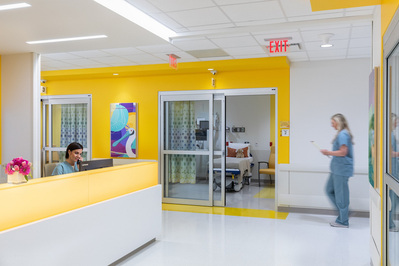 A modern children's hospital nurses' station designed by HKS Architects, featuring vibrant colors, clean lines, and a welcoming, functional layout that supports pediatric healthcare.