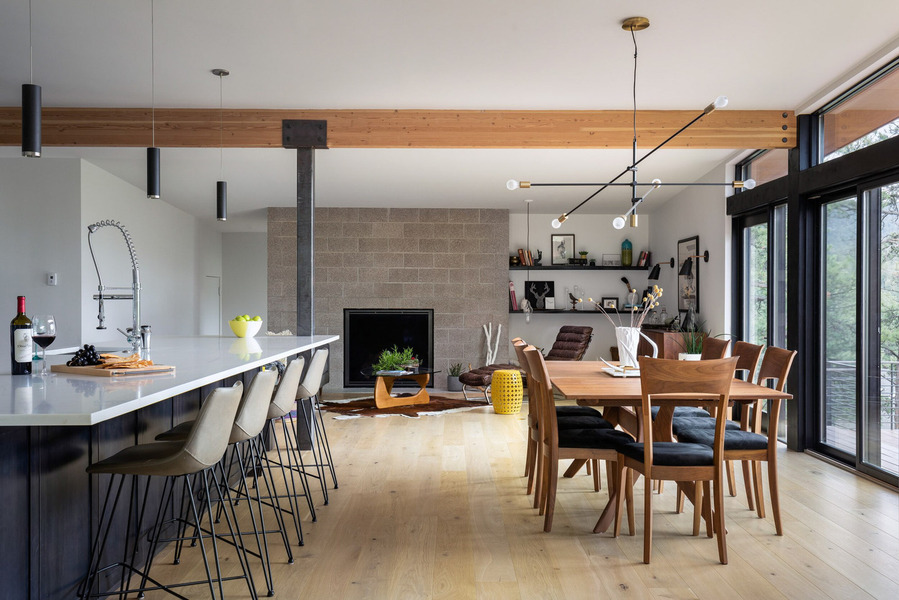 Midcentury modern home interior featuring dining room meeting kitchen and living room.