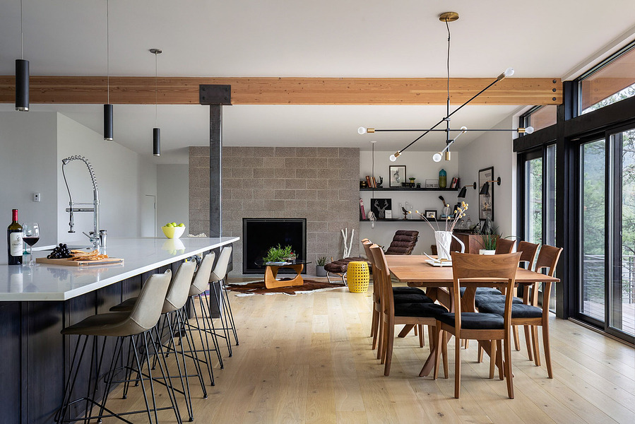 Midcentury modern home interior featuring dining room meeting kitchen and living room.