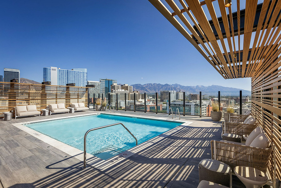 Rooftop pool at Le Meridien Salt Lake City, offering stunning mountain views, captured in a vibrant hotel photography setting.