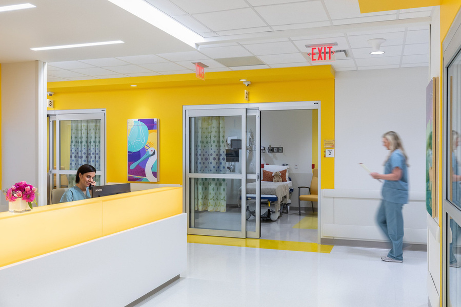 A modern children's hospital nurses' station designed by HKS Architects, featuring vibrant colors, clean lines, and a welcoming, functional layout that supports pediatric healthcare.