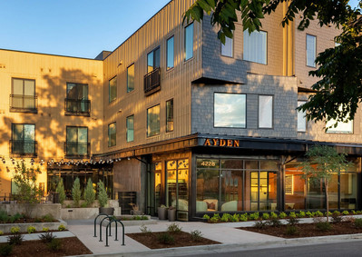Exterior of The Ayden multifamily building in Denver, taken during the golden hour to capture warm, natural lighting on the architecture.