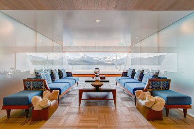 Interior photograph of the beach deck on a luxury mega yacht in Alaska, showcasing sleek finishes and open access to the surrounding seascape.
