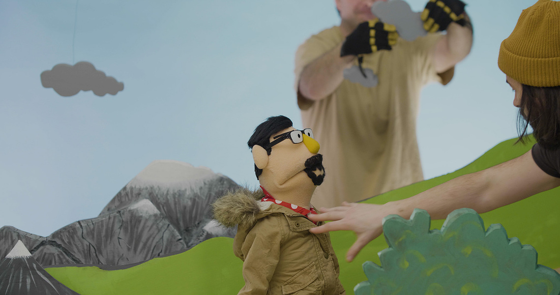 Still frame of Gerry Kingsley directing puppet Ed Landry on the set of 