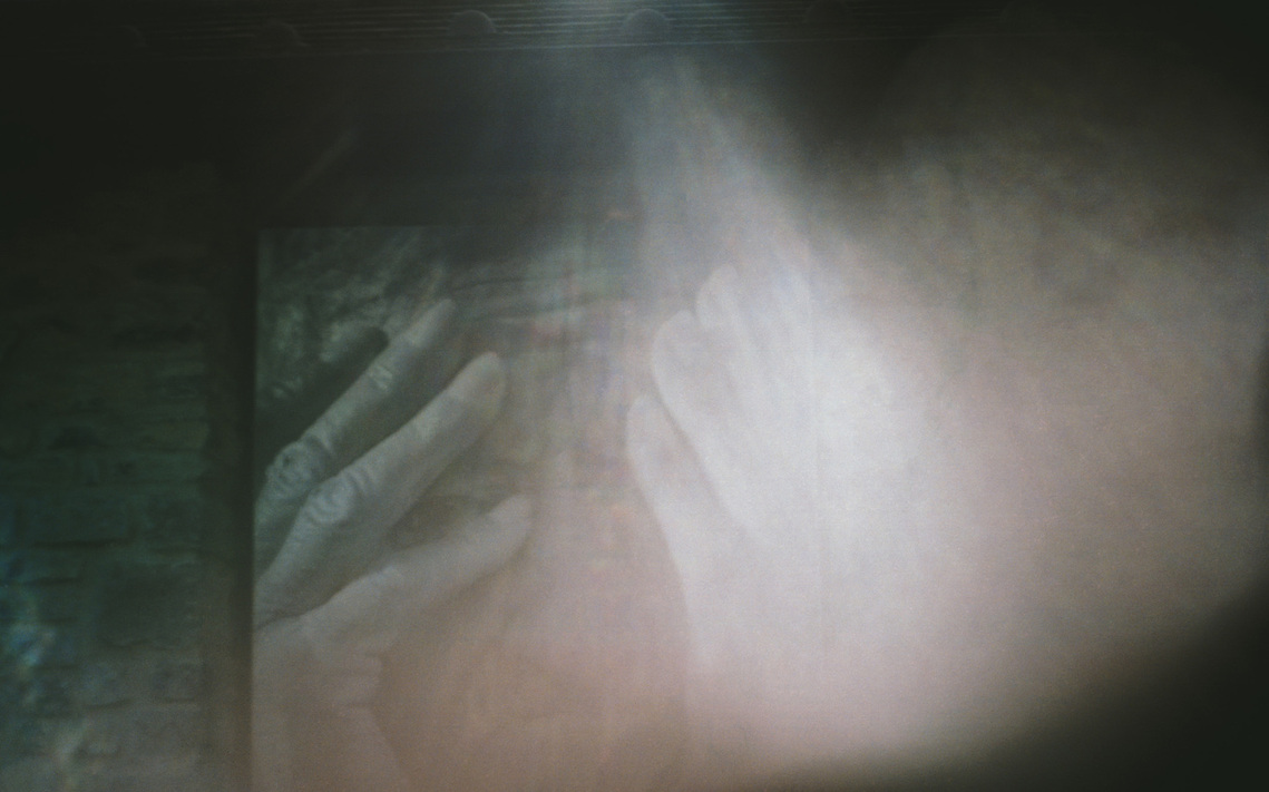 An elderly woman's hands bathed in a radiant halo of light, symbolizing grace and the profound beauty found in fleeting, everyday moments.