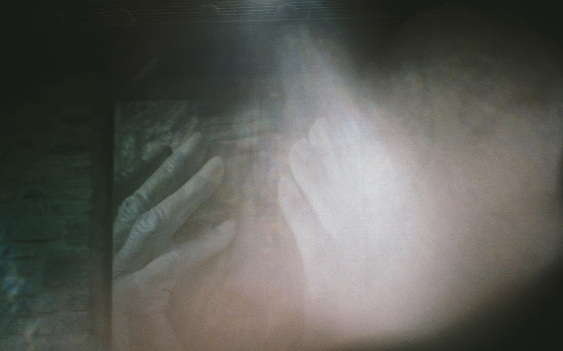 An elderly woman's hands bathed in a radiant halo of light, symbolizing grace and the profound beauty found in fleeting, everyday moments.