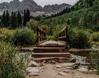 A footbridge crosses a creek in the Maroon Bells-Snowmass Wilderness