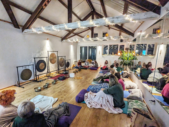 People gathered in a yoga studio ready for a sound  bath.
