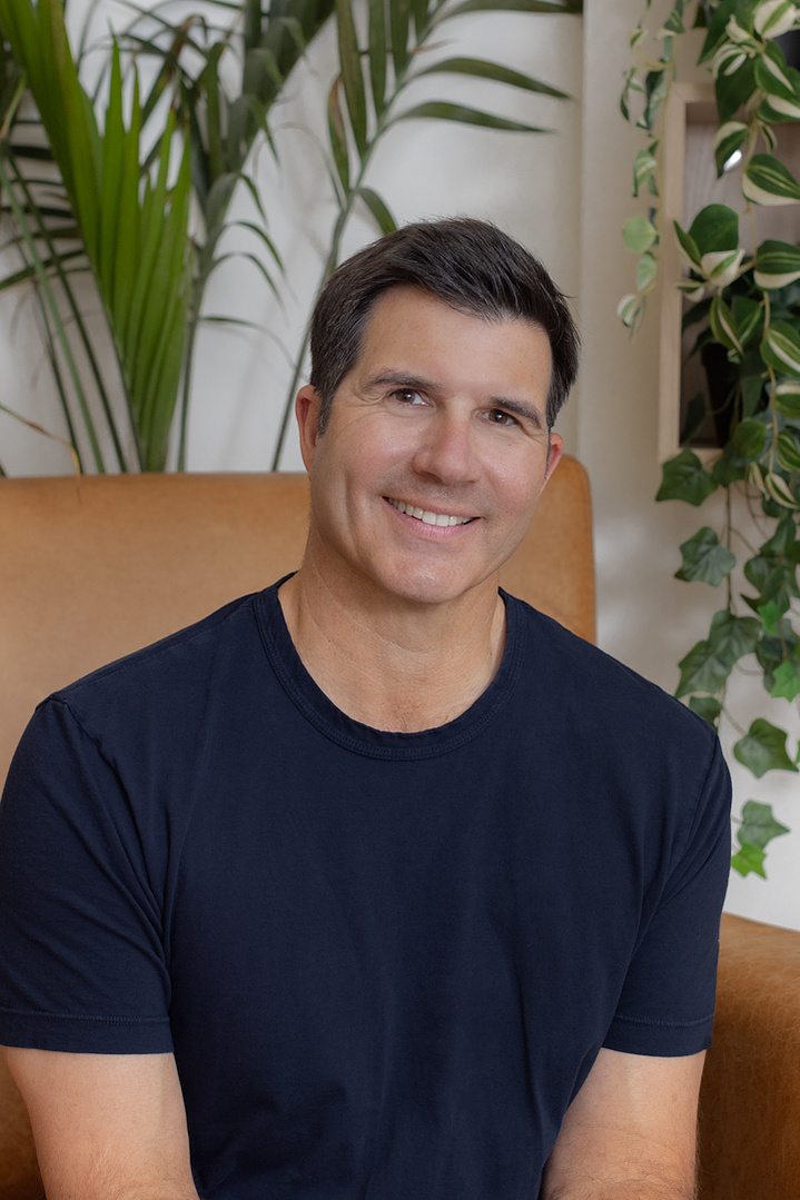 A professional headshot of a business owner, photographed in Atlanta, GA, showcasing confidence and approachability for corporate and personal branding.
