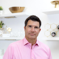 A clean and modern business headshot taken in Atlanta, GA, highlighting a business professional with natural lighting and a neutral background.