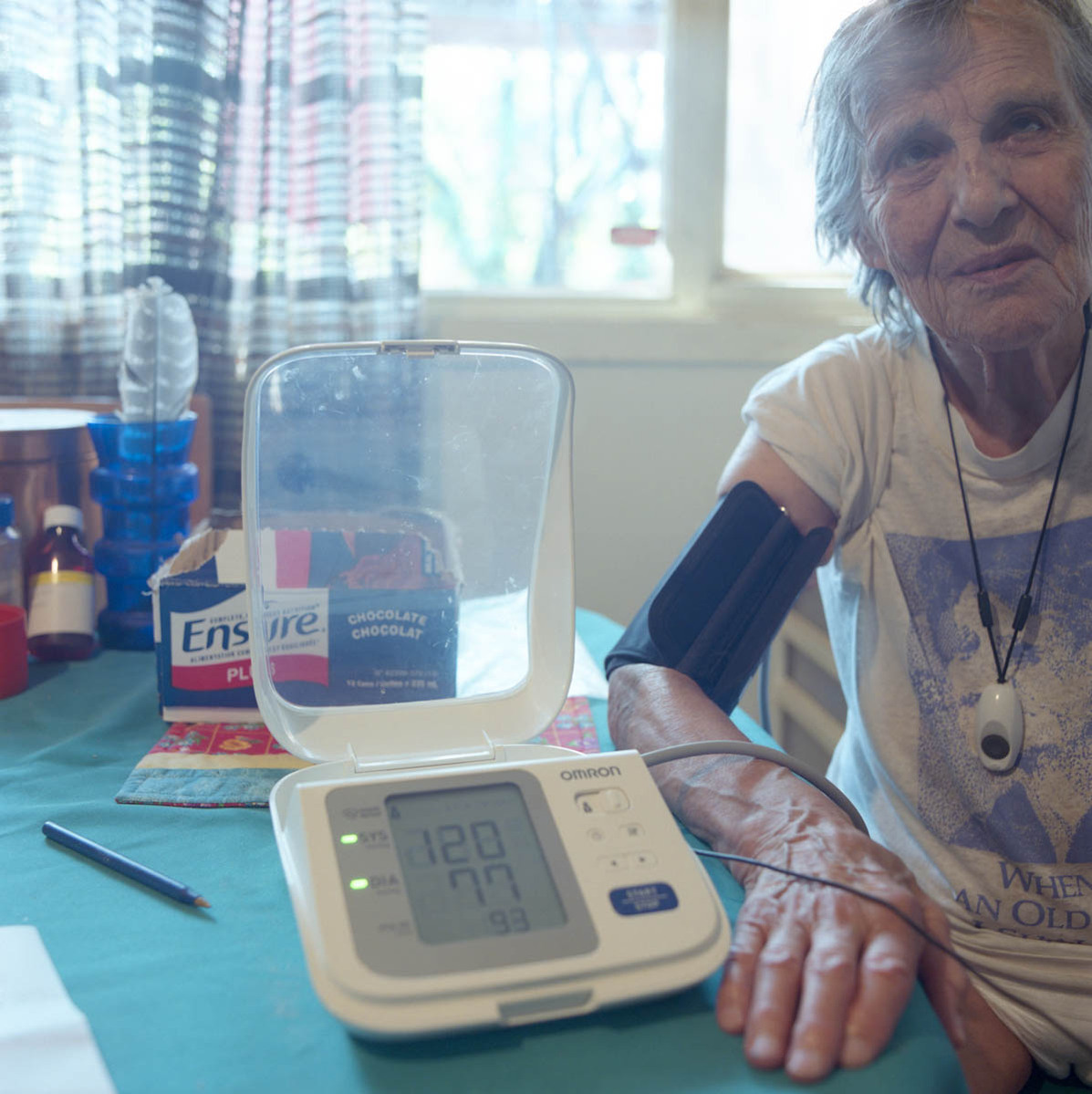 an elderly woman has her blood pressure taken in her home; part of a series on Medical Assistance in Dying