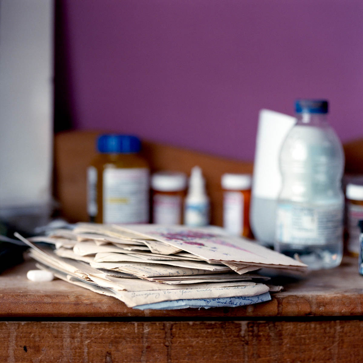 night table with old letters and medication on it; part of a series on Medical Assistance in Dying
