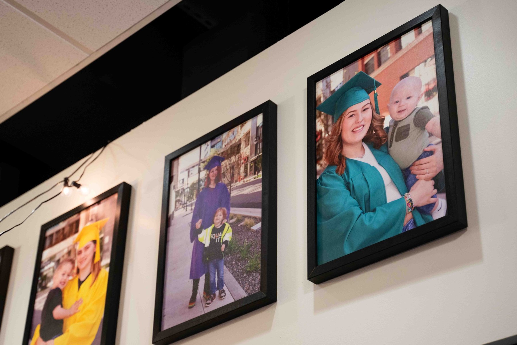 Photos of Lumen graduates line the school hallway.