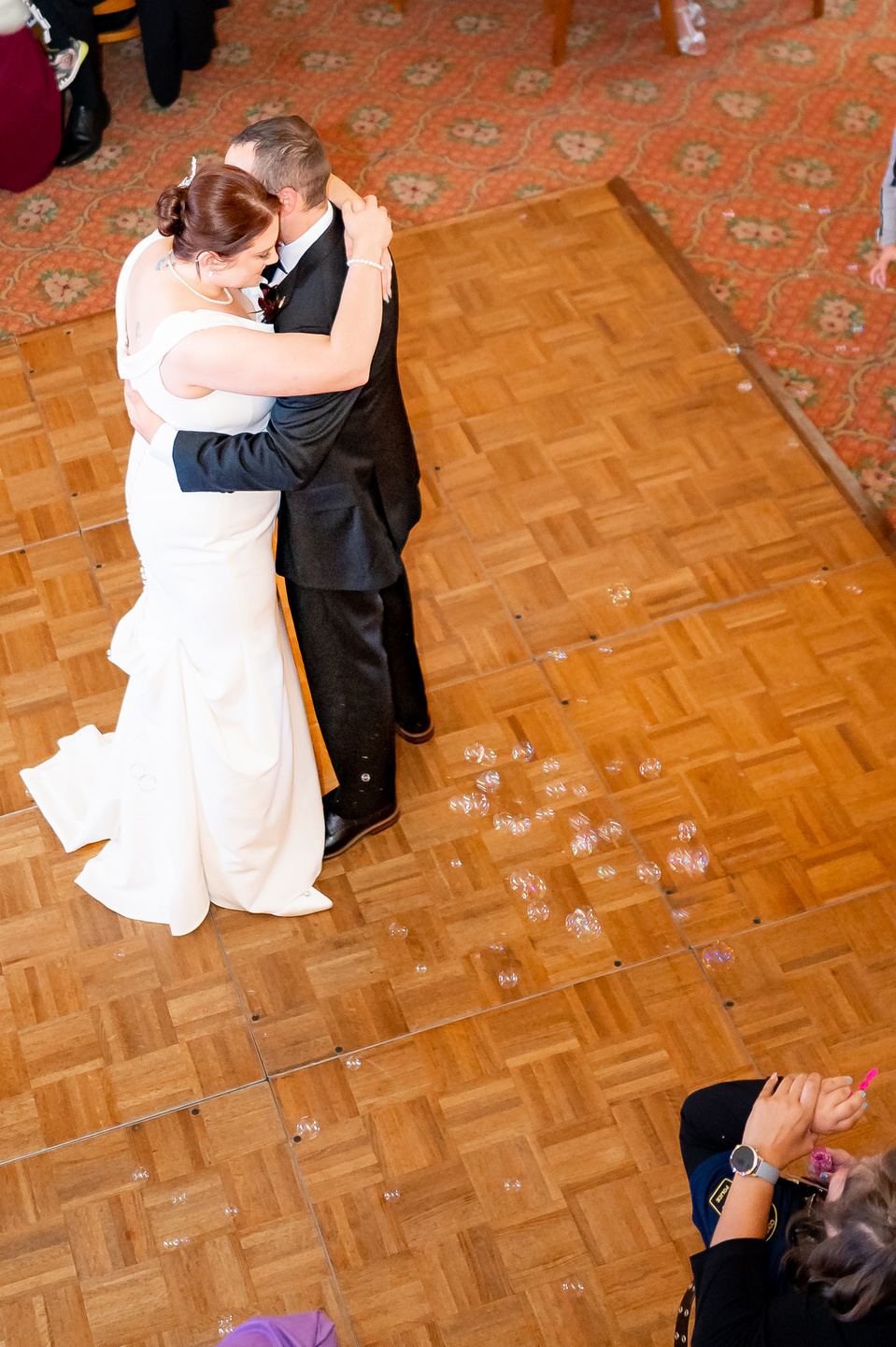 A slow dancing newlyweds on a dancing floor.