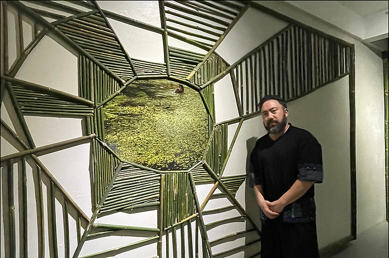 Ben Sloat, artist, with installation made of bamboo in the Philippines 