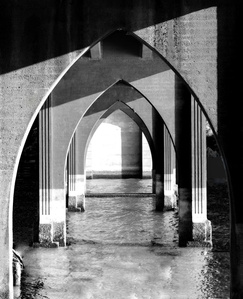 gothic arched bridge over water, black and white image