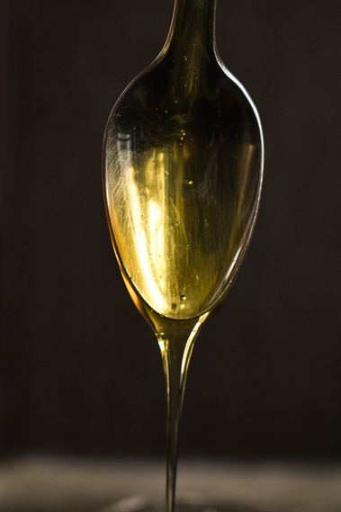 Honey running from a spoon (close-up) 