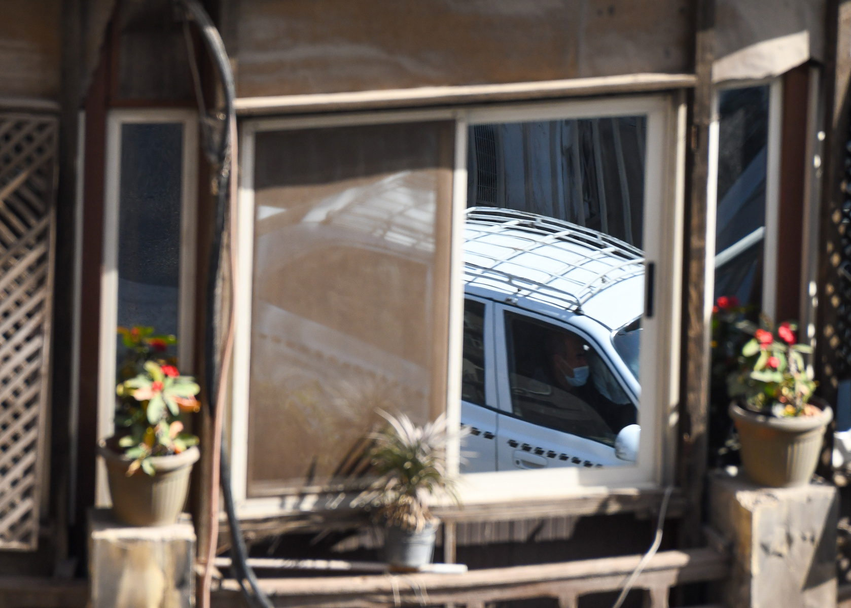 Reflection of a masked passenger inside a taxi — Cairo Egypt January 2021