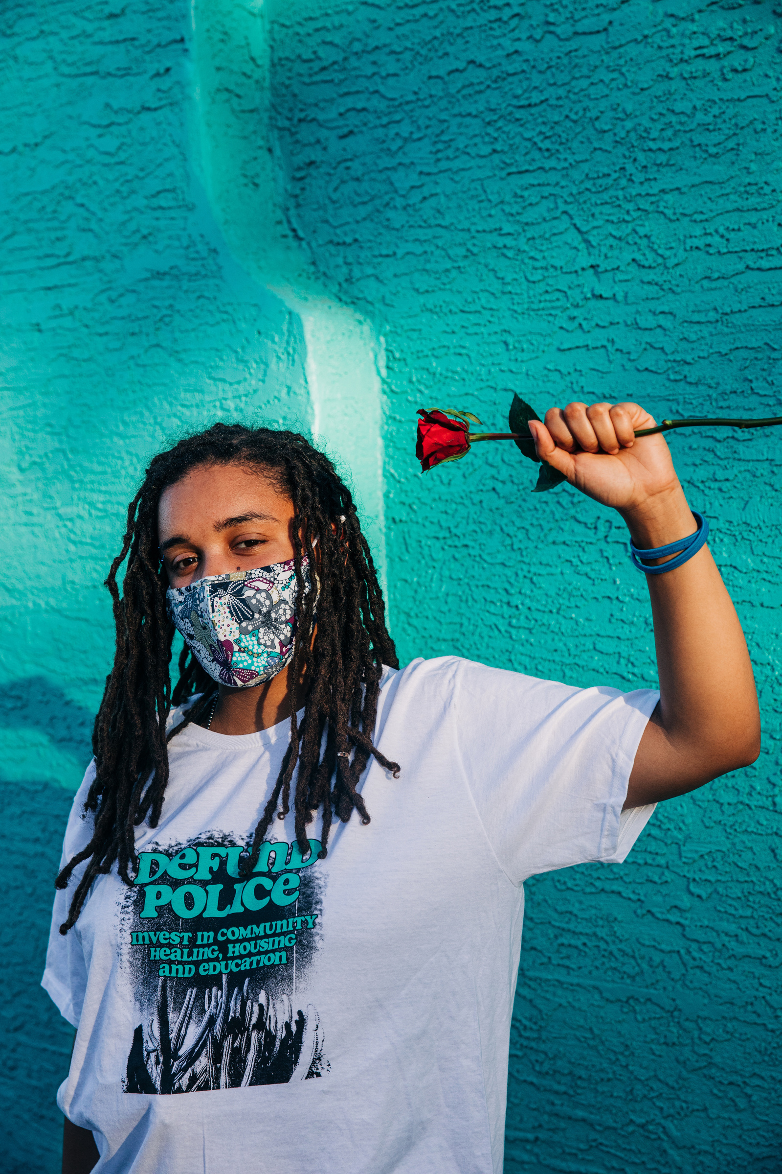 Zarra Teacola, organizer with Black Lives Matter Phoenix Metro wears a shirt designed by Phoenix artist Justine Juju García at a mural event organized by a coalition of artists and organizers to bring artist Giovannie Dixon (JUST) to create a mural to mem