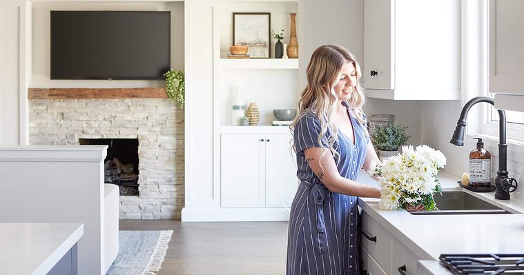 Interior designer Kathleen styles florals at the kitchen sink.
