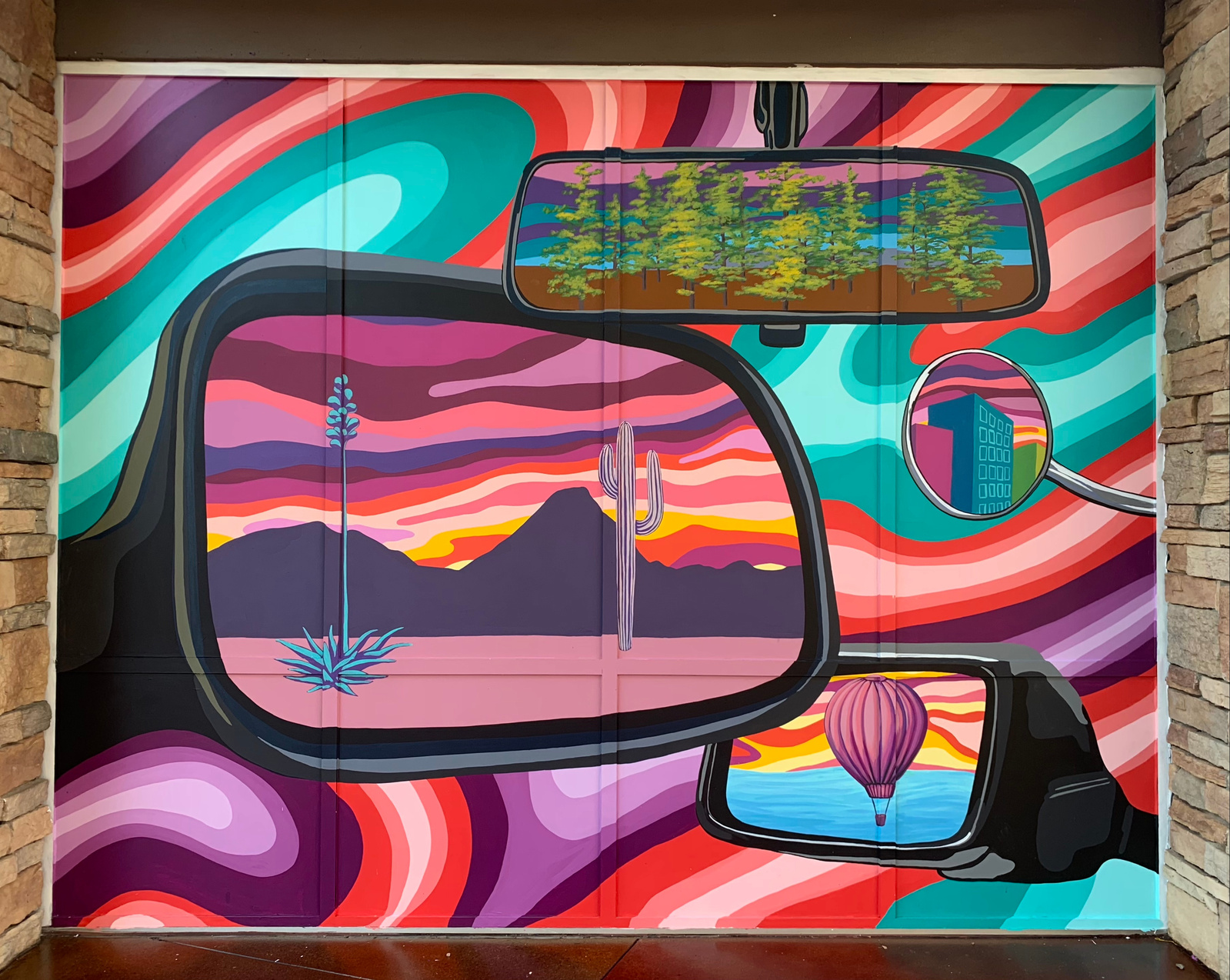 A painted travel-themed mural at Desert Ridge Marketplace by Kayla Newnam
