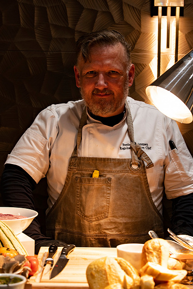 Executive chef preparing food at a corporate culinary event