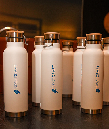 Branded water bottles displayed at a corporate networking event