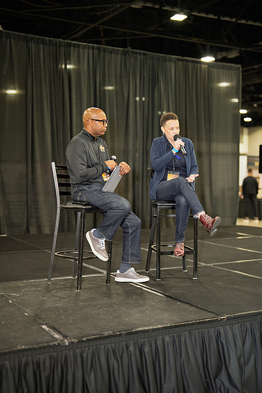 Speakers on stage during a conference fireside chat