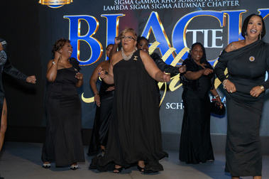 Guests in formalwear at a black-tie fundraiser gala