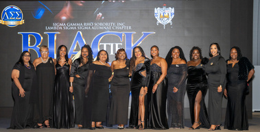 Group of women in formalwear at a black-tie fundraiser gala