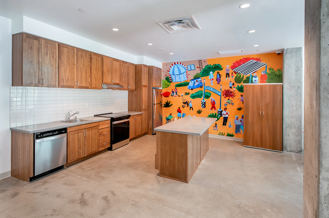 A vibrant mural by a Bay Area illustrator installed in a downtown San Mateo community room. This colorful artwork celebrates diversity, a blend of art, community, and inclusivity.
