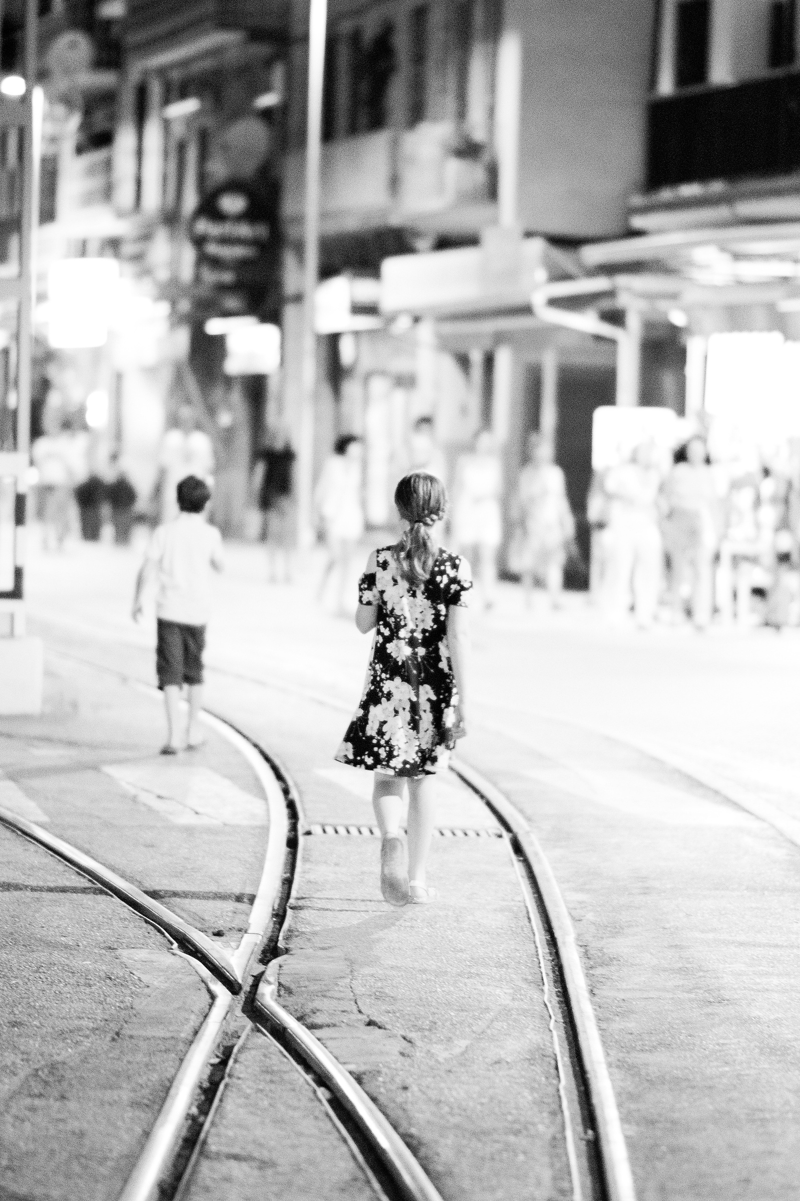 The girl walks along tram lines in Soller Port