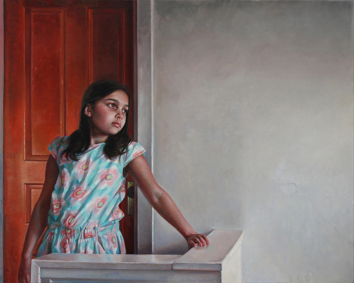 a girl in front of an orange door
