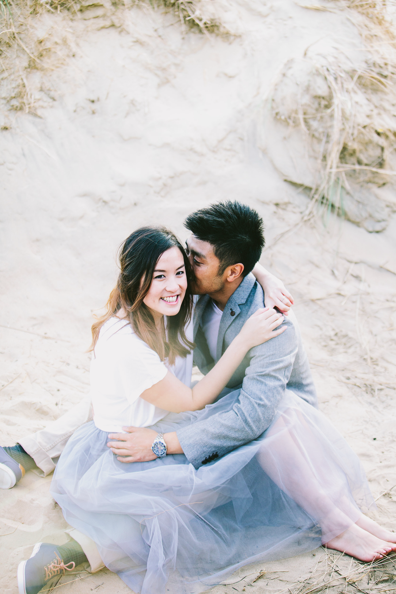 couple embracing on a beach in Camber Sands 
