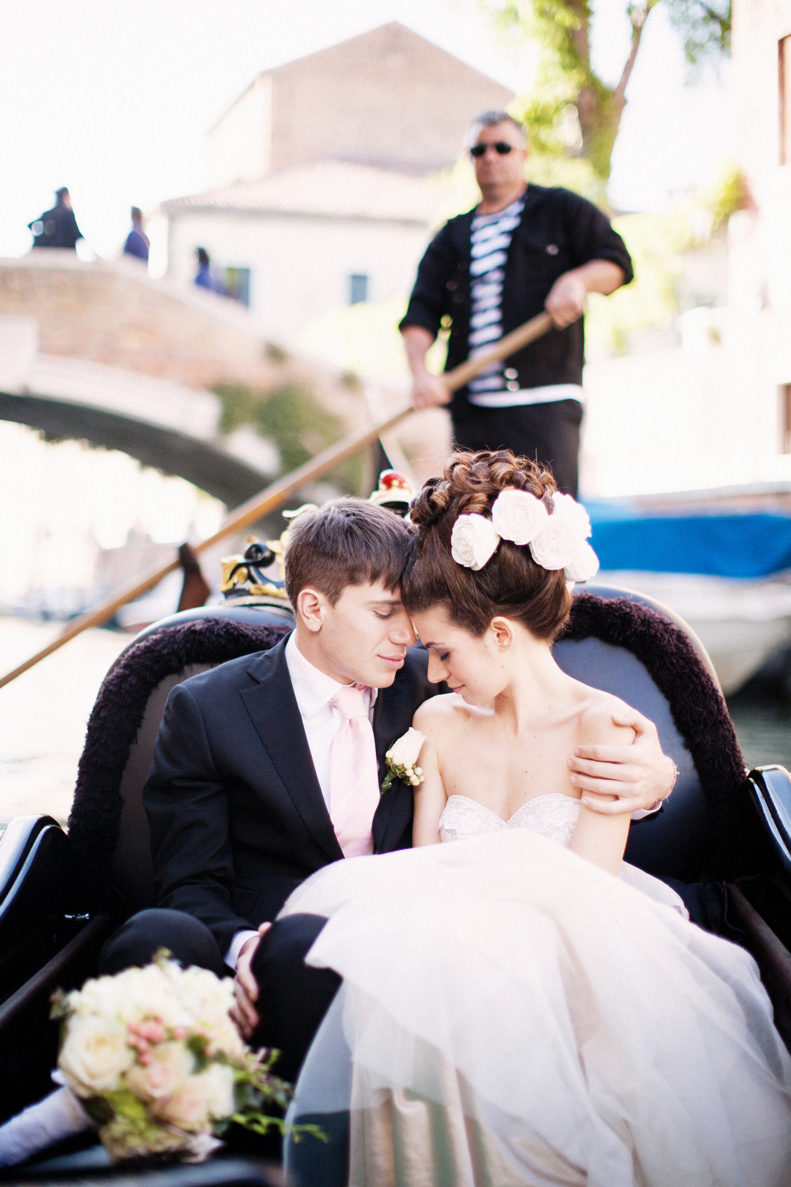 Couple in love touching heads and embracing on a gondola in Venice 