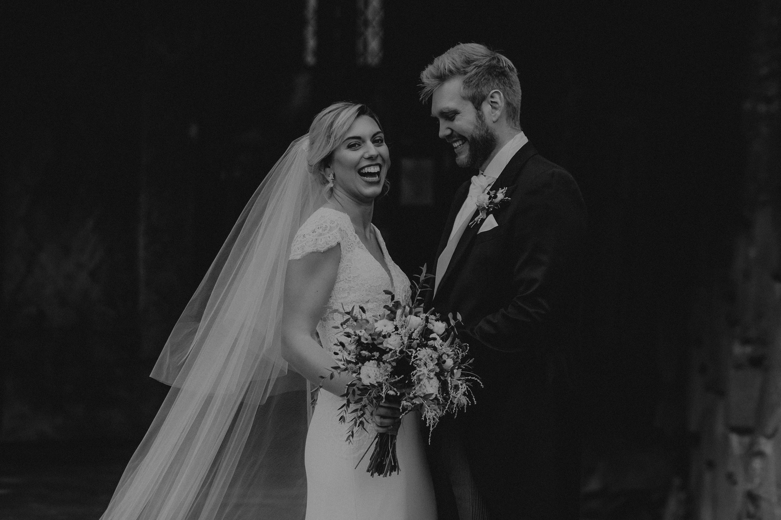 Couple sharing a joke after their wedding ceremony 