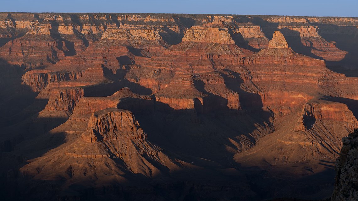 The long rays of the setting sun across the Grand Canyon in the fall.
