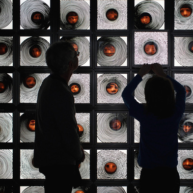 Limited edition art book When My Heart Stops Beating by Tasmanian artist Patrick Hall, documents the artwork at MONA. Artist and son in silhouette with the artwork of a grid of lit, manipulated LP records, faces and recordings of voices saying I Love You.