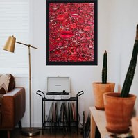 In-situ of large contemporary art collage entitled Gloss by Tasmanian visual artist Diane Allison of HALLISON Studios featuring hundreds of red pouting lips from magazines against a black ground, on a white wall in a living room with record player.