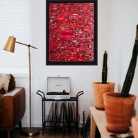 In-situ of large contemporary art collage entitled Gloss by Tasmanian visual artist Diane Allison of HALLISON Studios featuring hundreds of red pouting lips from magazines against a black ground, on a white wall in a living room with record player.