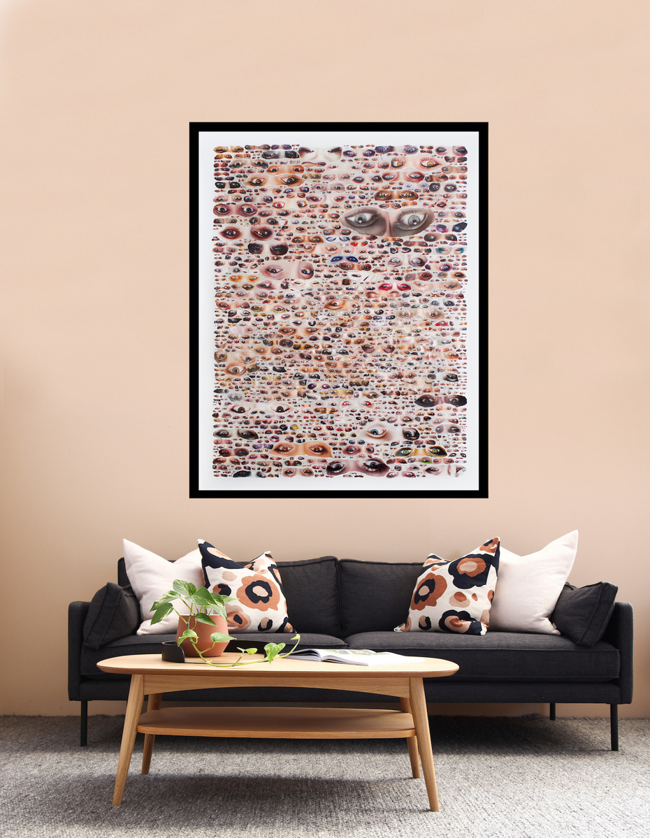 Large collage artwork by Tasmanian contemporary artist Diane Allison of HALLISON Studios of dozens of hand torn upside down images of eyes from fashion magazines entitled Glare. Art in-situ on a beige living room wall with wooden coffee table & dark couch