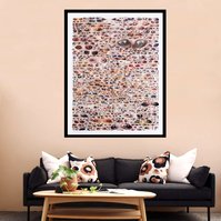 Large collage artwork by Tasmanian contemporary artist Diane Allison of HALLISON Studios of dozens of hand torn upside down images of eyes from fashion magazines entitled Glare. Art in-situ on a beige living room wall with wooden coffee table & dark couch