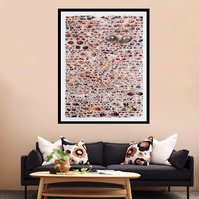 Large collage artwork by Tasmanian contemporary artist Diane Allison of HALLISON Studios of dozens of hand torn upside down images of eyes from fashion magazines entitled Glare. Art in-situ on a beige living room wall with wooden coffee table & dark couch