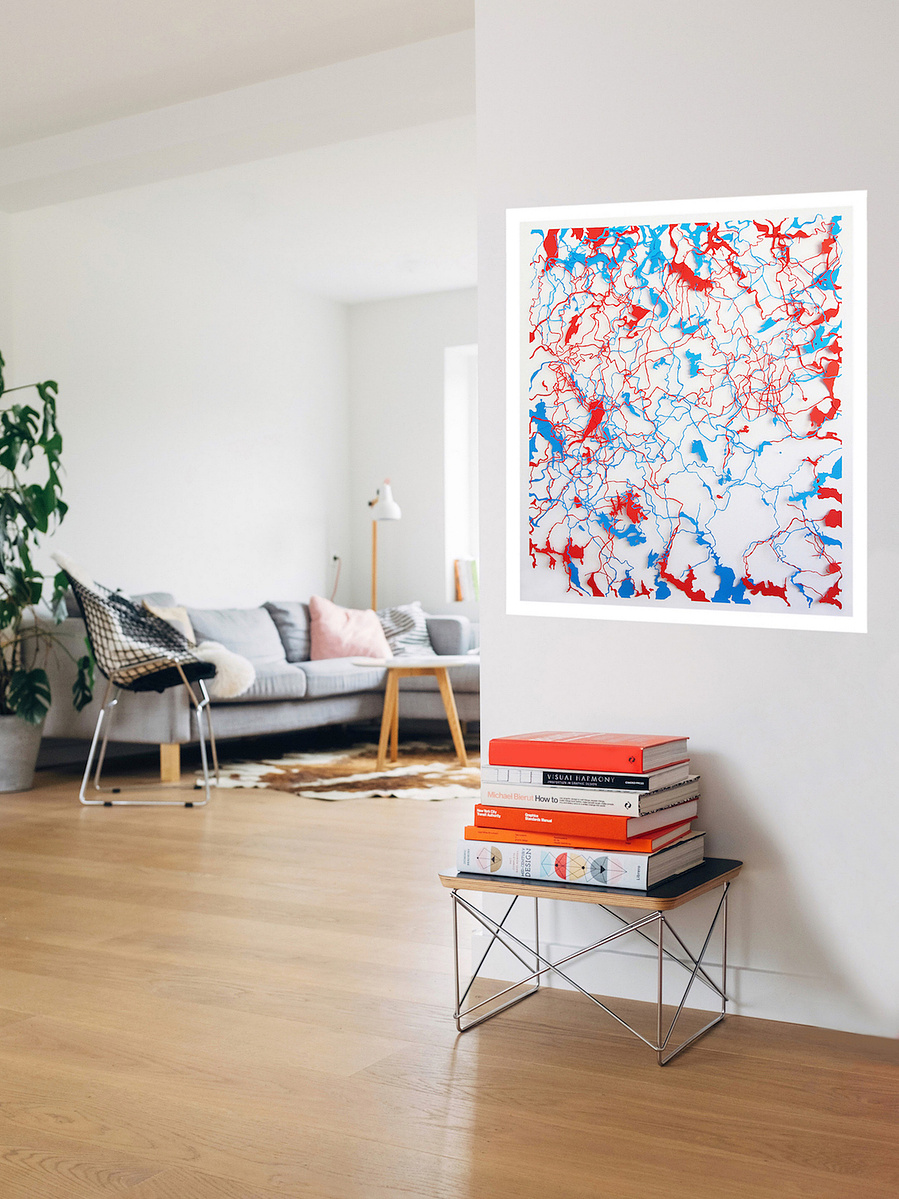 Contemporary art in-situ in sunny living room, grey sofa, white walls. Body of Water by artist Di Allison HALLISON Studios.Tasmanian rivers as cut paper of blue & red, white background. Suggests body's circulatory system. Glover Art Prize finalist