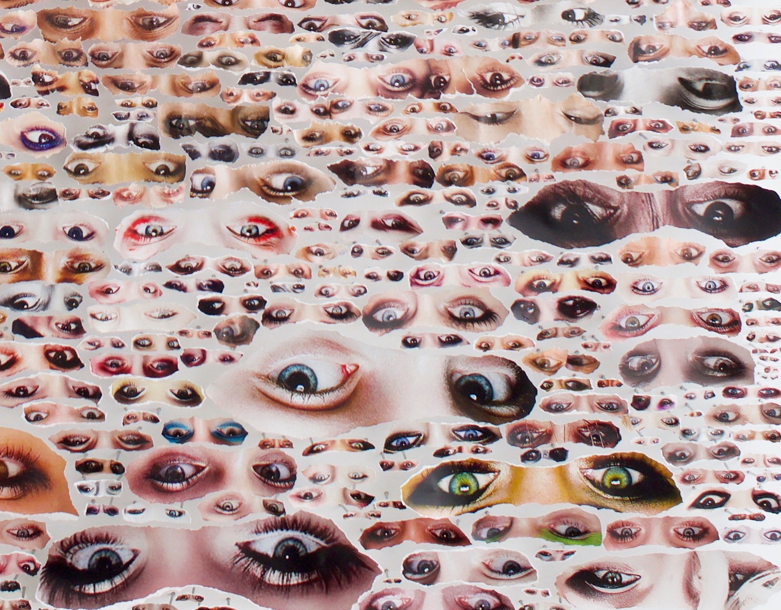 Close-up image of large collage artwork by Tasmanian contemporary artist Diane Allison of HALLISON Studios featuring dozens of hand torn images of eyes from fashion magazines against a white back ground entitled Glare.