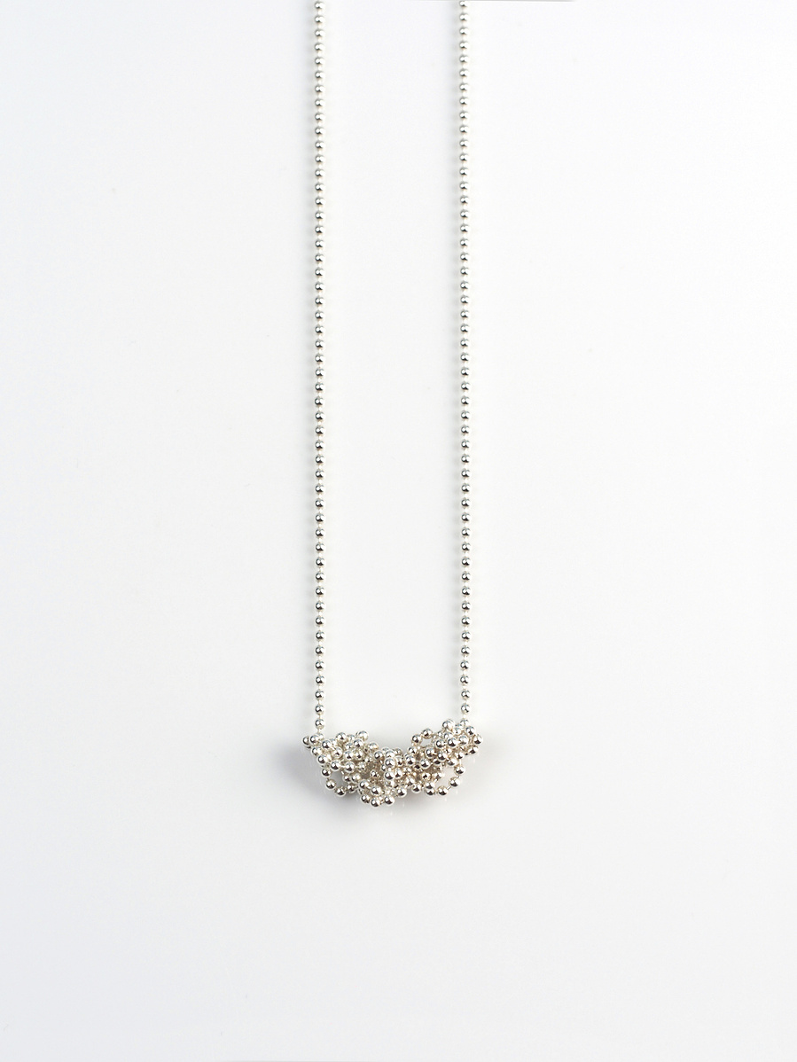 Handmade sterling silver pendant from the Knit 1 Purl 1 [K1 P1] series on a white background by contemporary jeweller Di Allison of HALLISON Studios, Tasmania. Features beaded sterling silver.