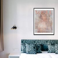In-situ art in a bedroom with green pillows, Fake Muse #2 a large collage by Tasmanian contemporary visual artist Diane Allison, HALLISON Studios made of hand cut squares of Elle fashion magazine covers which form a large up scaled magazine cover.
