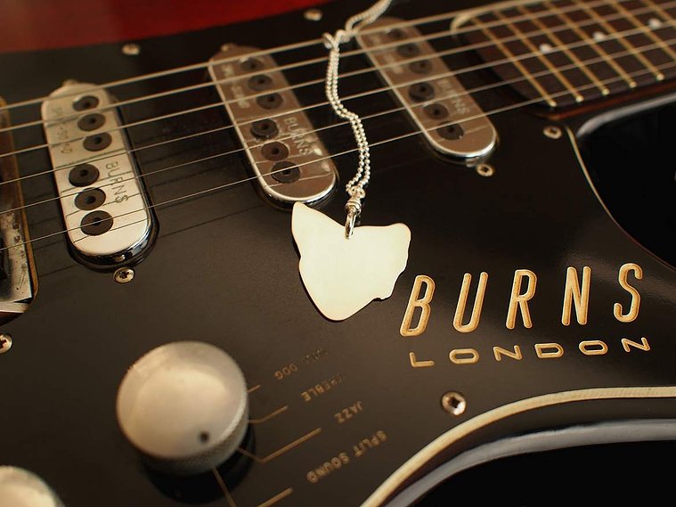 Van Diemen's detachable, wearable sterling silver guitar pick pendant, Di Allison, HALLISON Studios, online jewellery. Music inspired jewelry, bijoux, shape of Tasmania, map of Tassie photographed on a vintage 1960s electric Burns of London guitar.