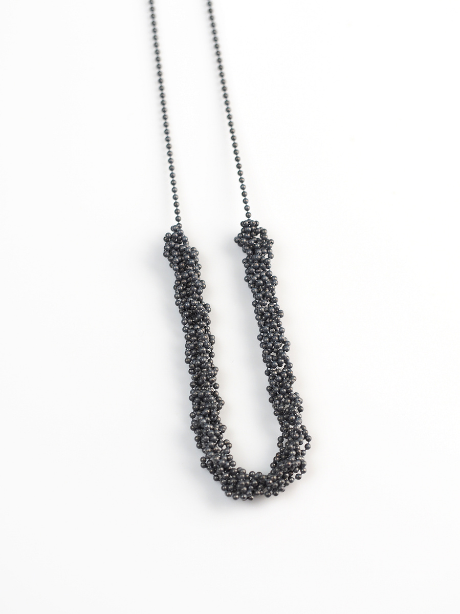 Handmade sterling silver pendant from the Knit 1 Purl 1 [K1 P1] series on a white background by contemporary jeweller Di Allison of HALLISON Studios, Tasmania. Features oxidised beaded sterling silver.